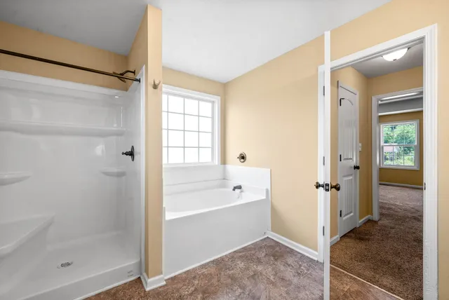 a bathroom with a bathtub shower and a sink