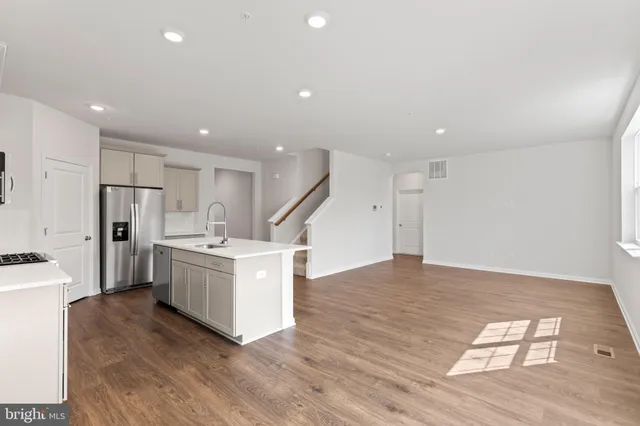 a kitchen with stainless steel appliances a refrigerator and a stove top oven