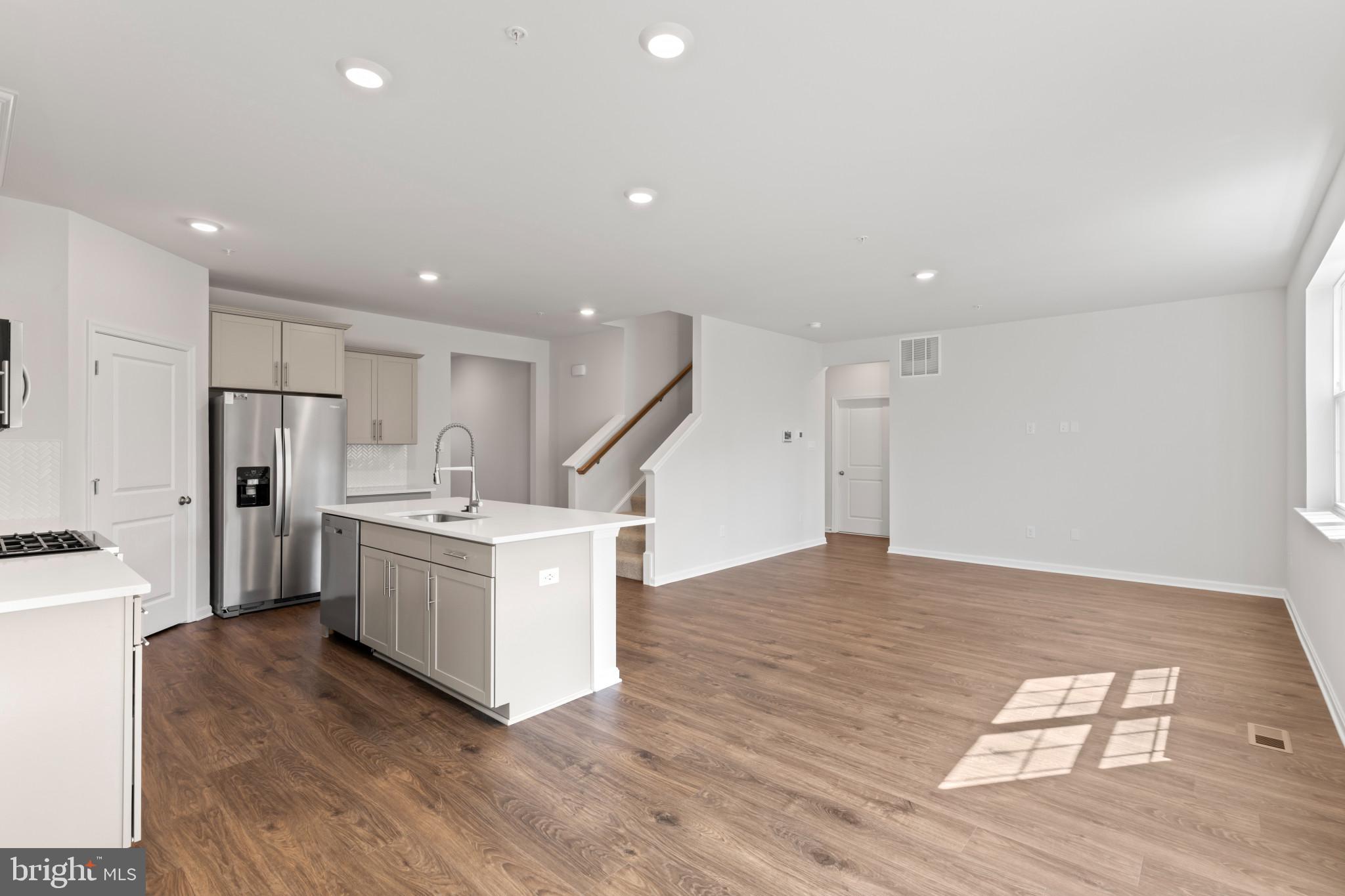 562 Atkinson Street Charles Town, WV 25414 - Photo 9 of 33 a kitchen with stainless steel appliances a refrigerator and a stove top oven