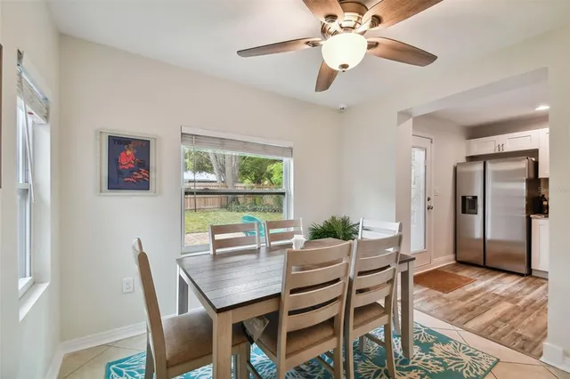 a dining room with furniture a chandelier and wooden floor