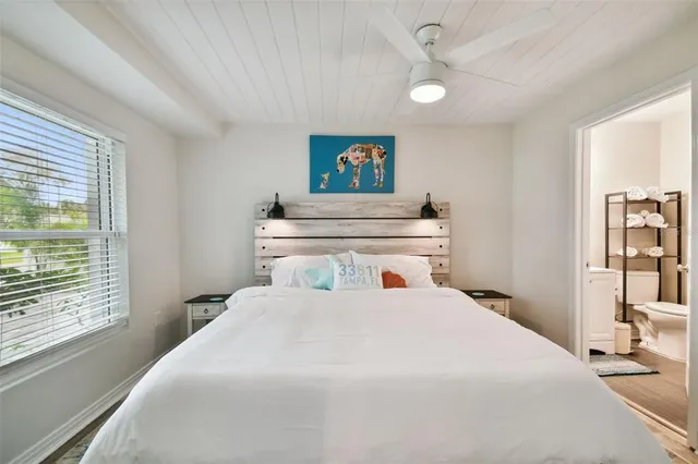 a bedroom with a large bed and a window