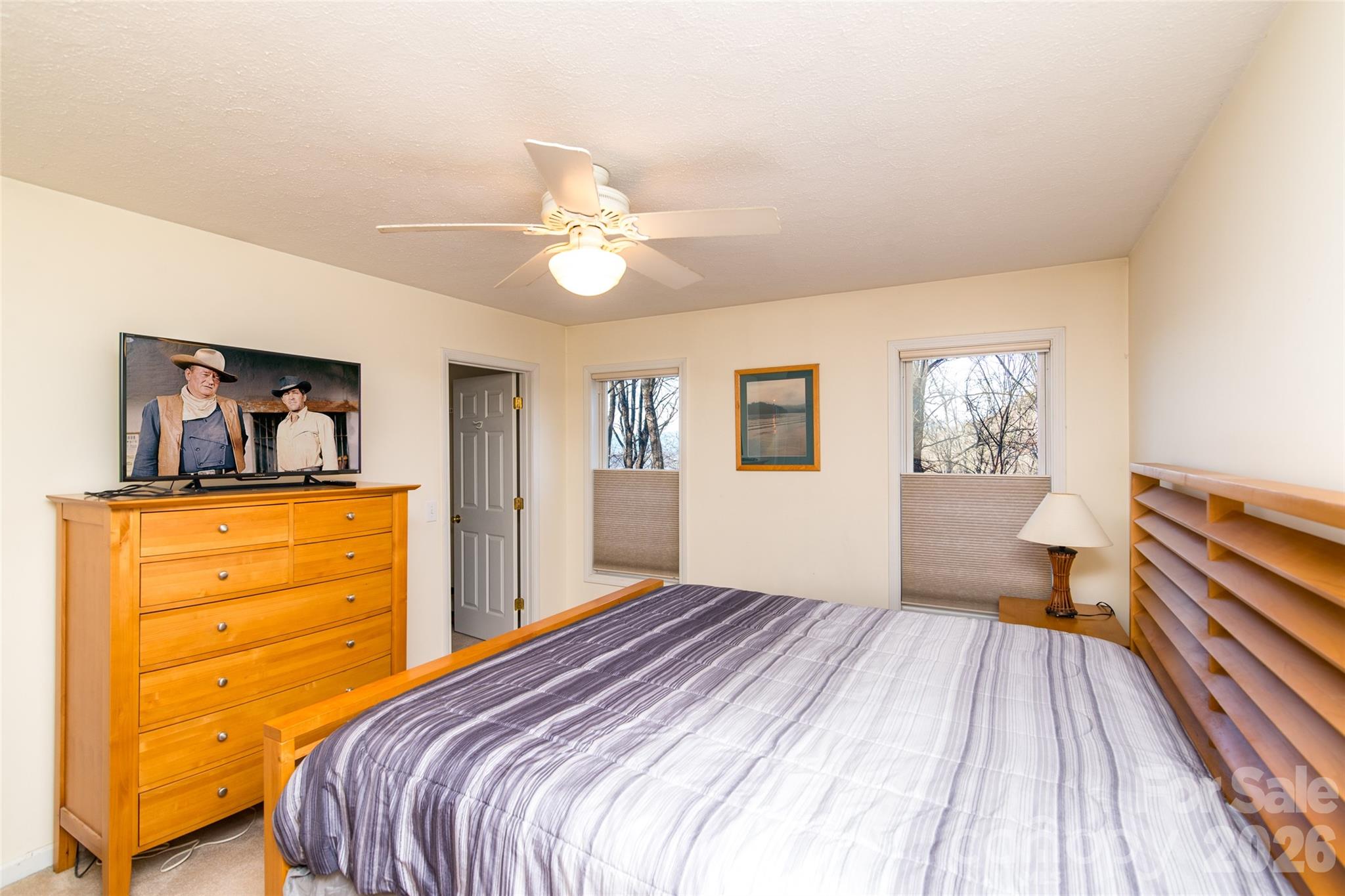 194 Ridgeview Drive Whittier, NC 28789 - Photo 17 of 43 a bedroom with a bed and a chandelier