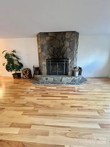 a view of living room with furniture and a fireplace