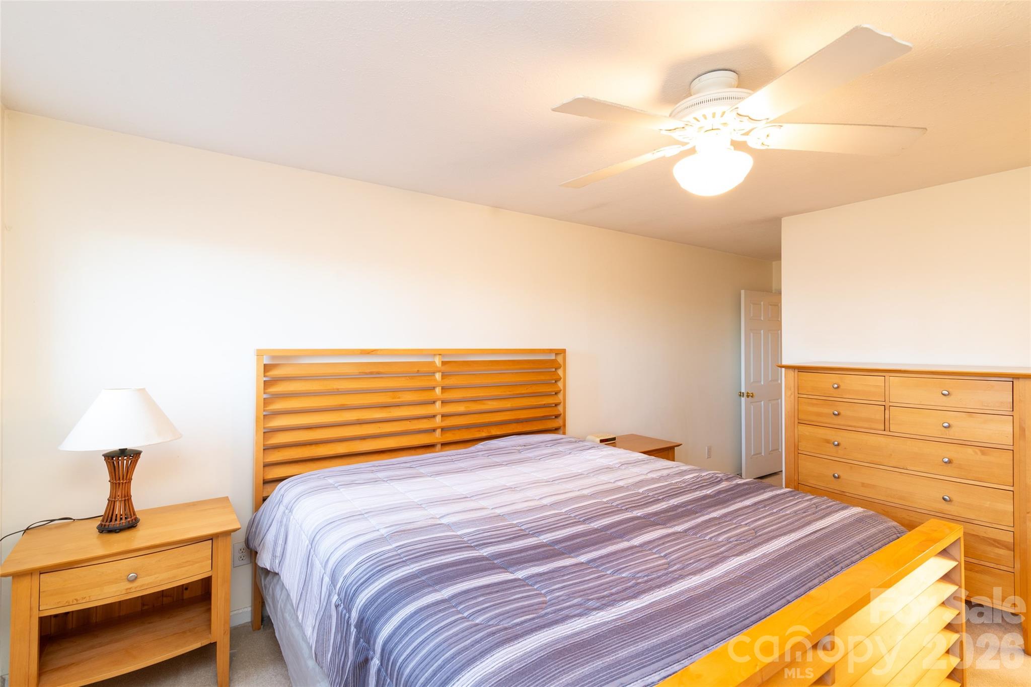 194 Ridgeview Drive Whittier, NC 28789 - Photo 18 of 43 a bedroom with a bed and a chandelier