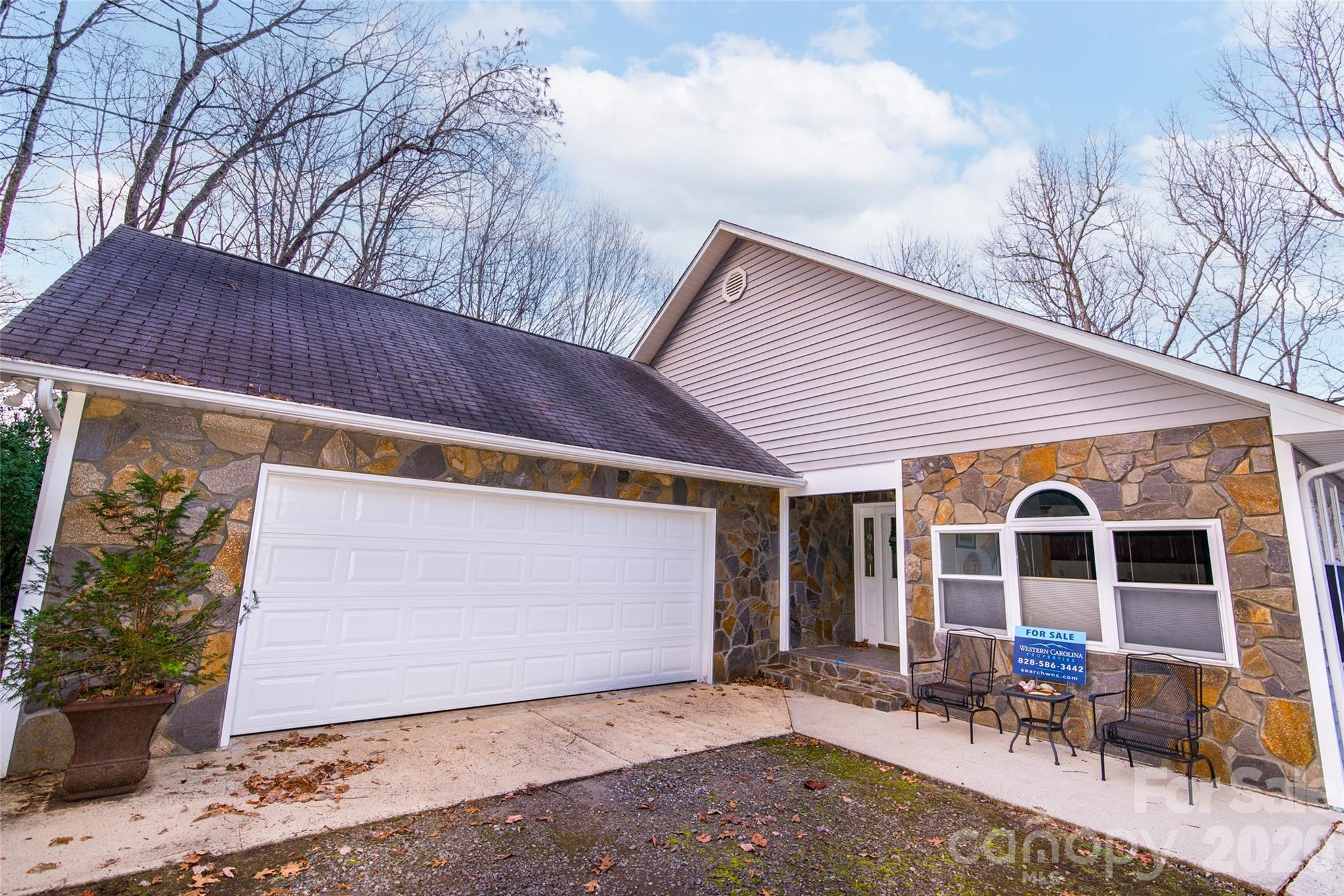 194 Ridgeview Drive Whittier, NC 28789 - Photo 2 of 43 a front view of a house with outdoor seating and barbeque oven