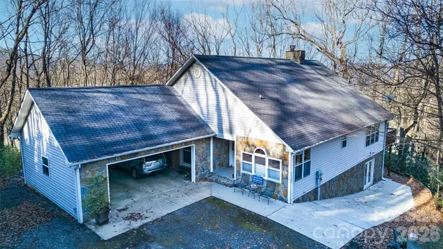 a view of a house with a yard and wooden fence