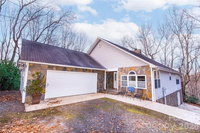 a view of a house with a yard covered in snow