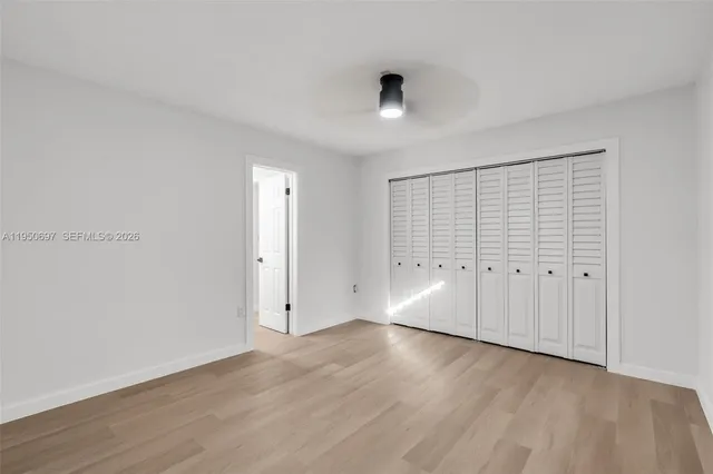 a bathroom with a sink a toilet and a large mirror