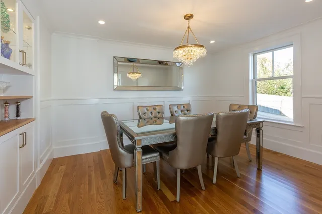 a view of a dining room with furniture wooden floor and chandelier