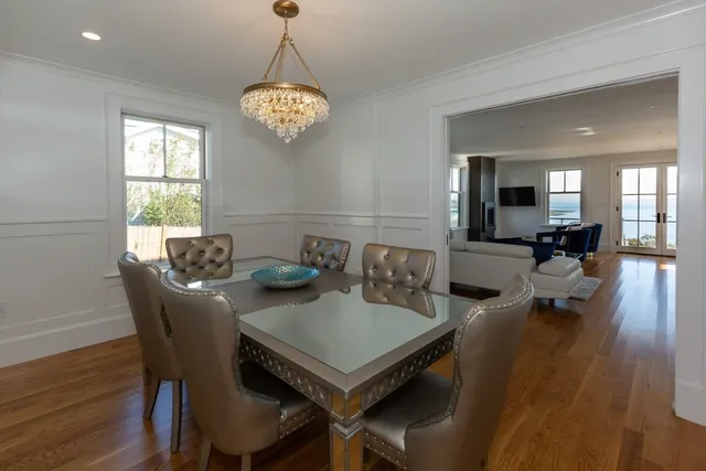 a view of a dining room with furniture wooden floor and a chandelier