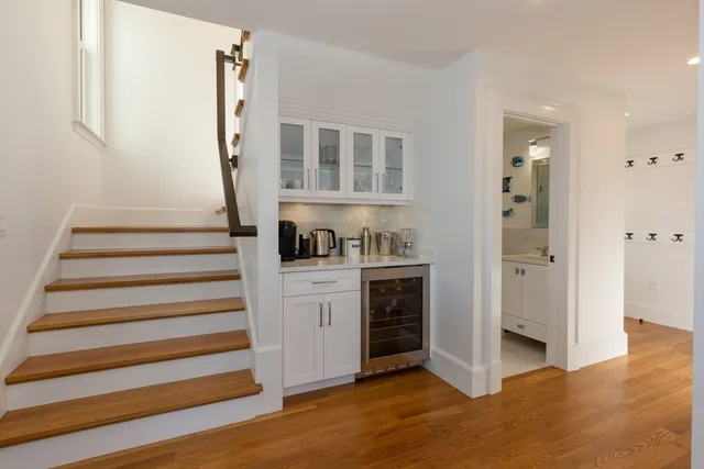 a view of entryway with wooden floor and cabinets