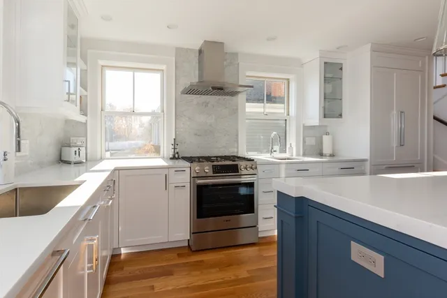 a kitchen with a sink stove top oven and cabinets