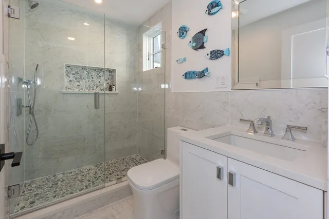 a bathroom with a sink toilet and shower