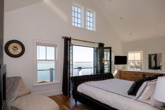 a bedroom with a large bed and a window