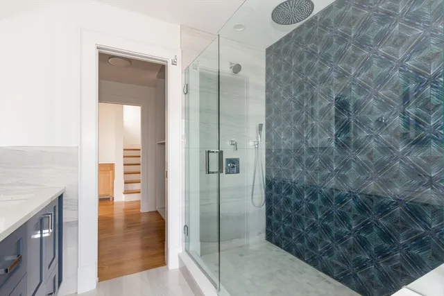 a bathroom with a shower and a sink