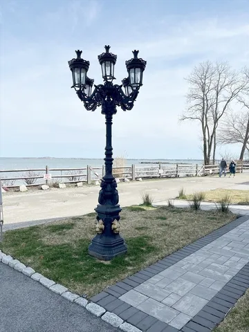a front view of a house with a yard and lake view