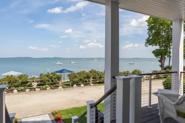 a view of a porch with a floor to ceiling window next to a yard