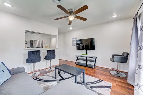 a living room with furniture and a flat screen tv
