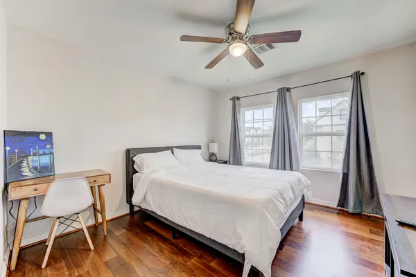 a large bed sitting in a bedroom next to a window