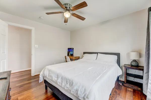 a bedroom with a bed and a chandelier