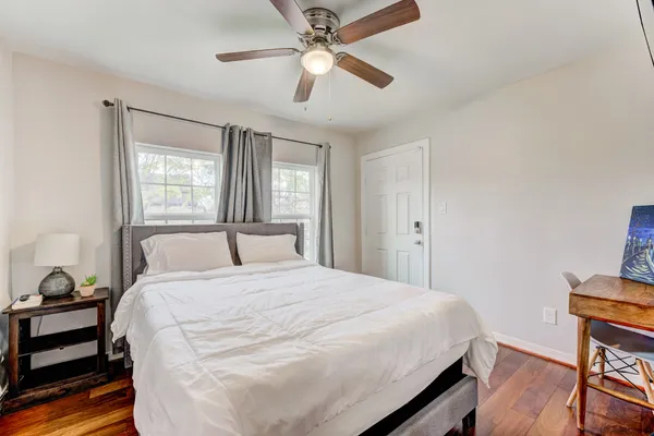 a bedroom with a bed and a chandelier