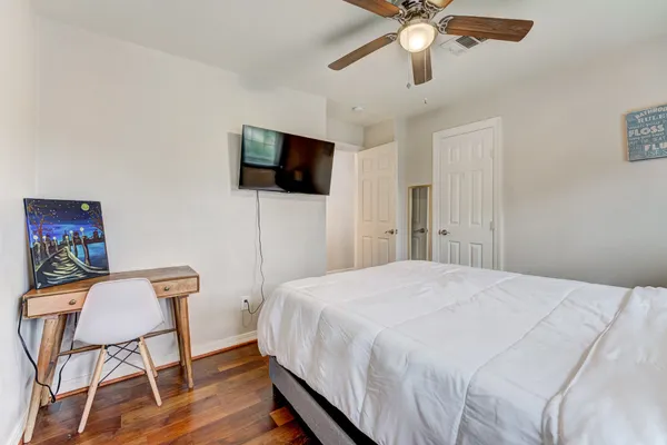 a bedroom with a bed and a flat screen tv