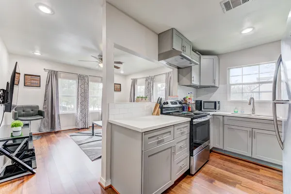 a kitchen with stainless steel appliances granite countertop a stove and a sink