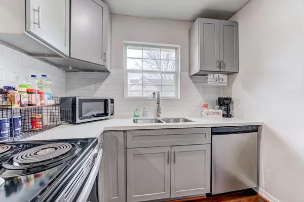 a kitchen with stainless steel appliances granite countertop a sink stove and cabinets
