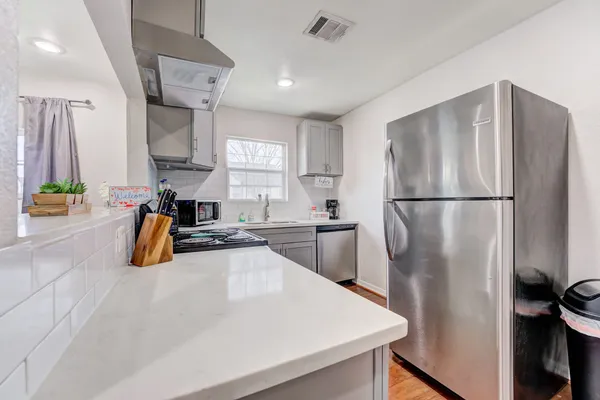a kitchen with refrigerator and window