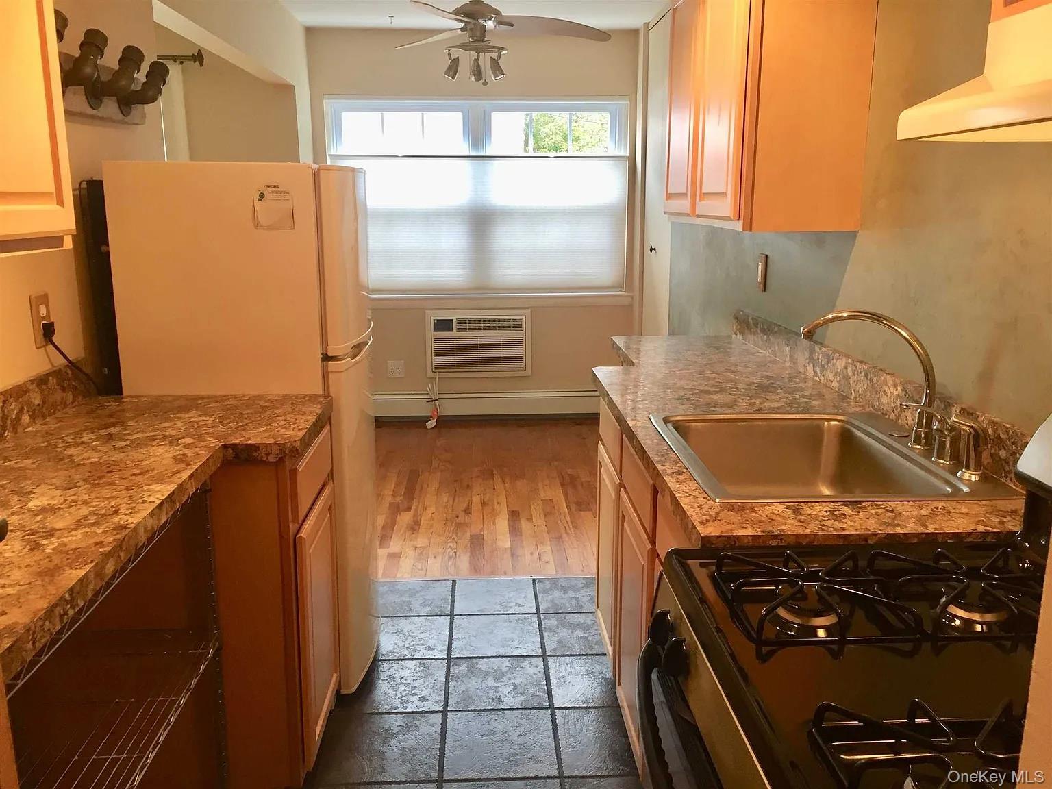a bathroom with a granite countertop sink a washer and dryer