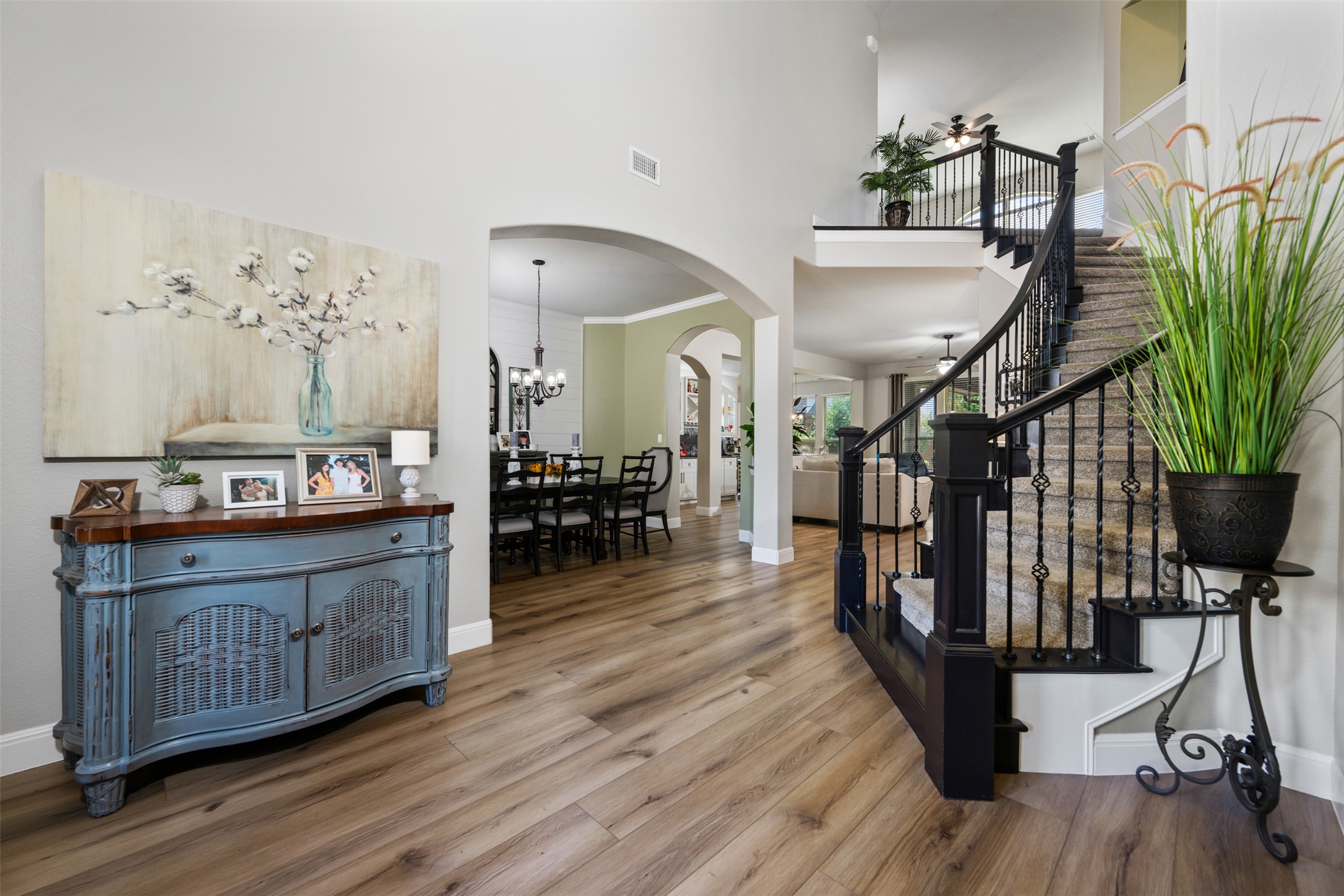 3021 Wedgescale Pass Leander, TX 78641 - Photo 4 of 40 a living room with furniture a wooden floor and a chandelier