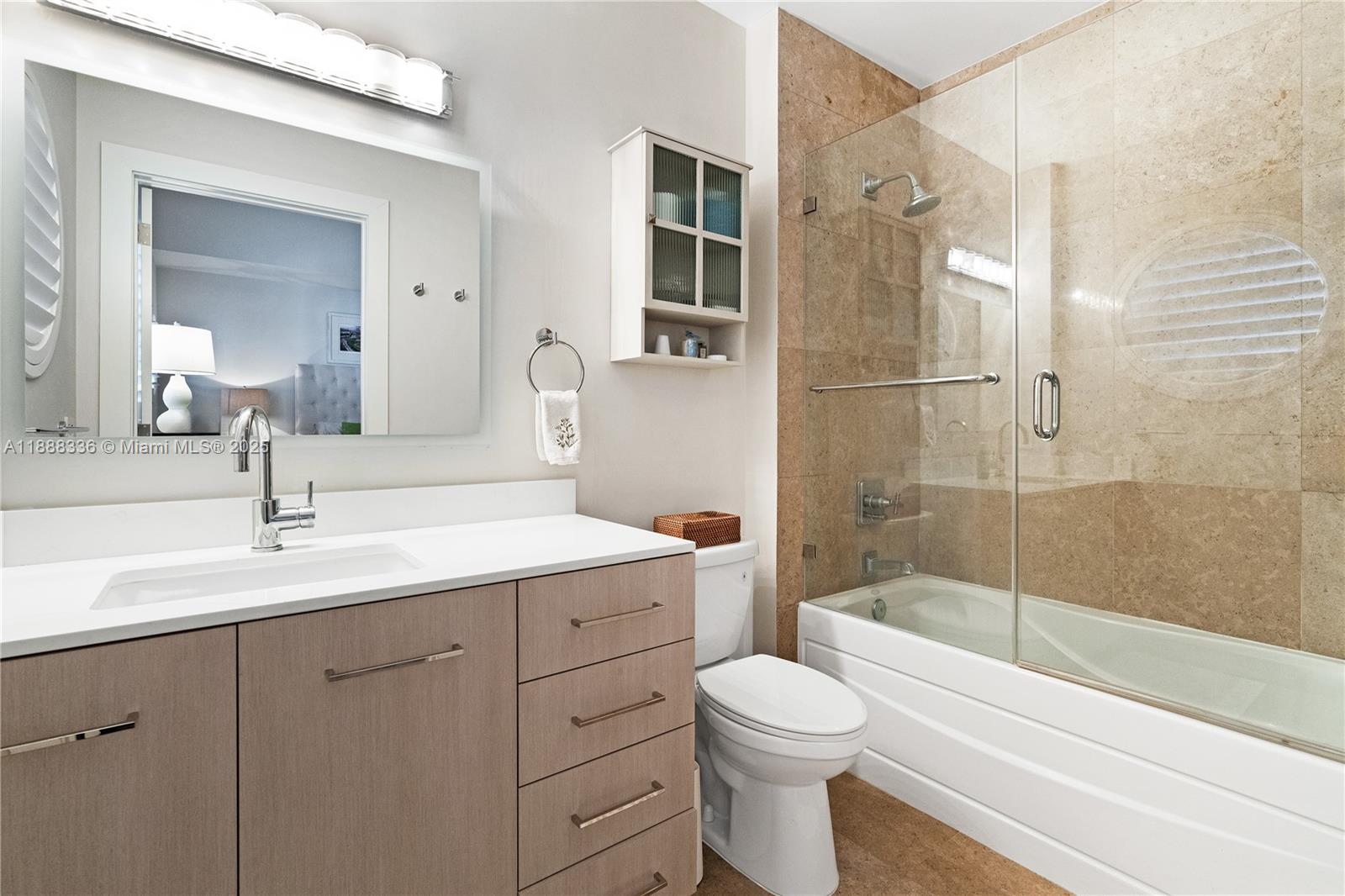 3739 Collins Avenue, Unit N605 Miami Beach, FL 33140 - Photo 13 of 20 a bathroom with a sink a toilet and shower