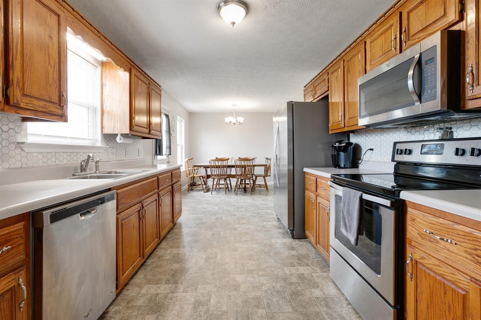 372 Freeland Road Portland, TN 37148 - Photo 16 of 41 a kitchen with stainless steel appliances granite countertop a stove a sink and a microwave