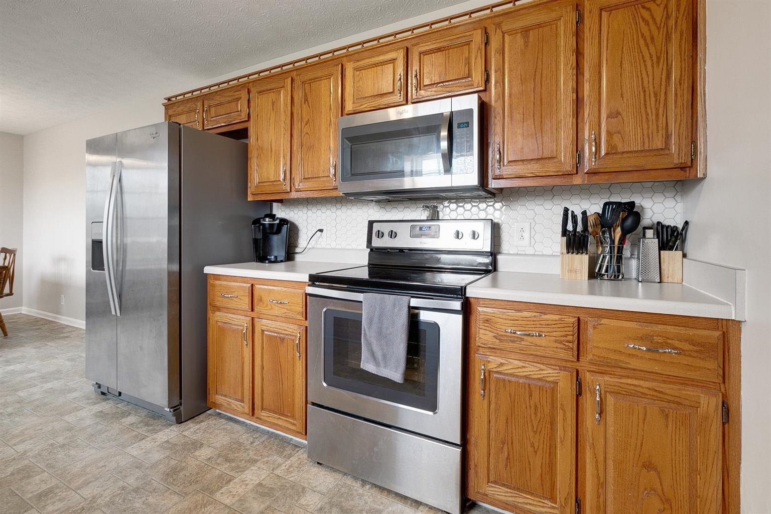 372 Freeland Road Portland, TN 37148 - Photo 17 of 41 a kitchen with stainless steel appliances granite countertop a stove microwave and refrigerator