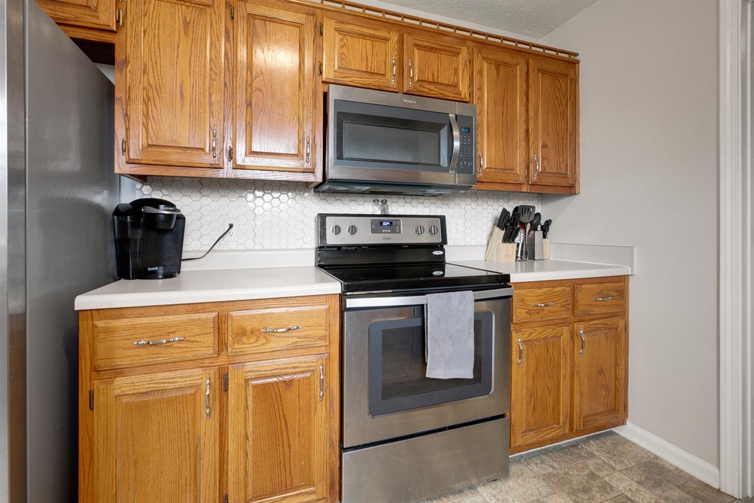 372 Freeland Road Portland, TN 37148 - Photo 20 of 41 a kitchen with stainless steel appliances granite countertop a stove a microwave and cabinets