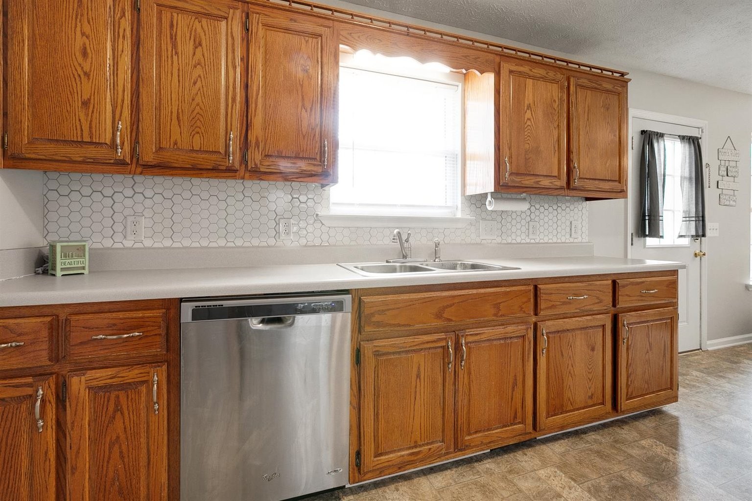 372 Freeland Road Portland, TN 37148 - Photo 21 of 41 a kitchen with stainless steel appliances granite countertop a sink and cabinets with wooden floor