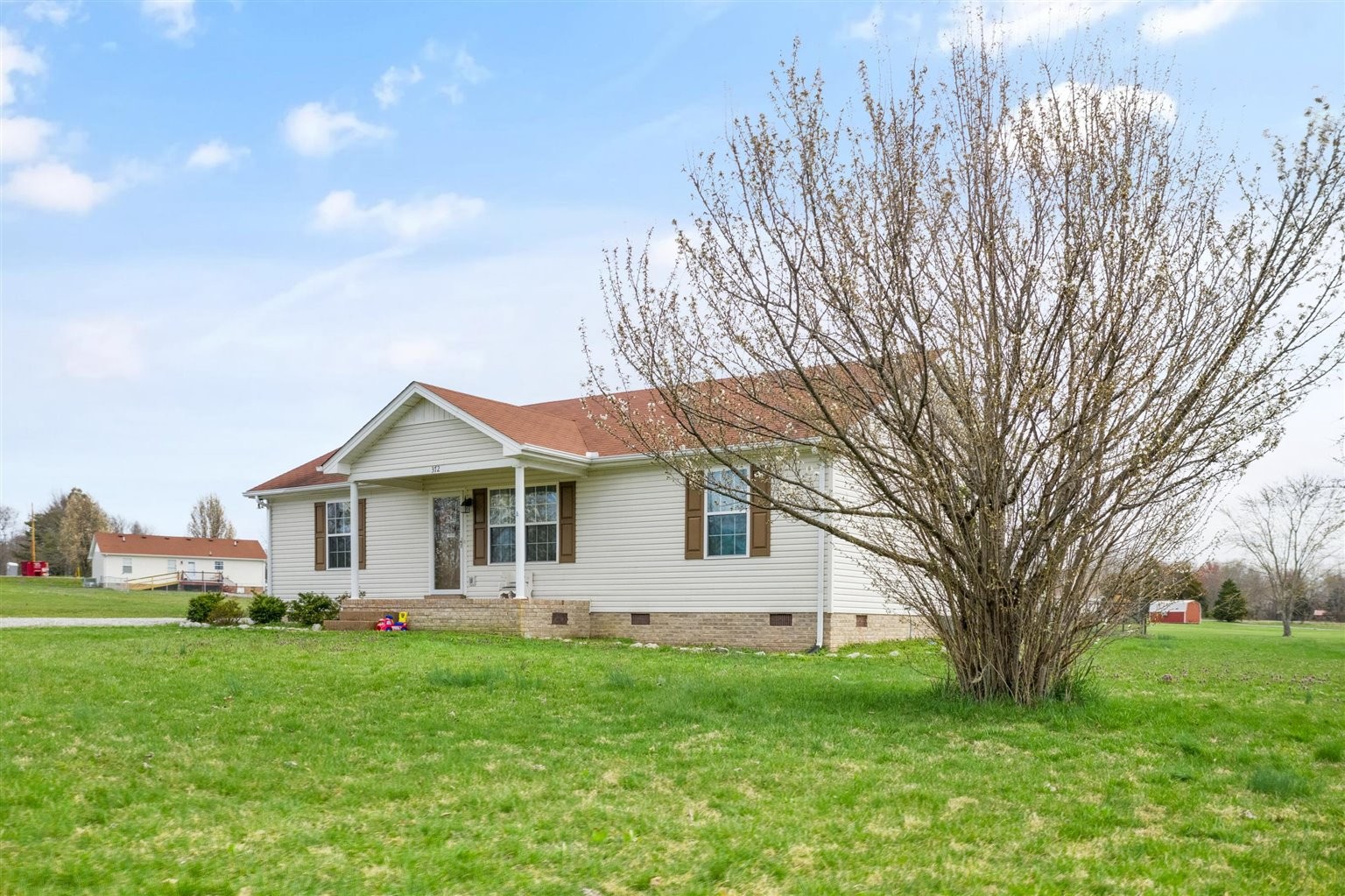372 Freeland Road Portland, TN 37148 - Photo 31 of 41 a front view of a house with a garden and trees