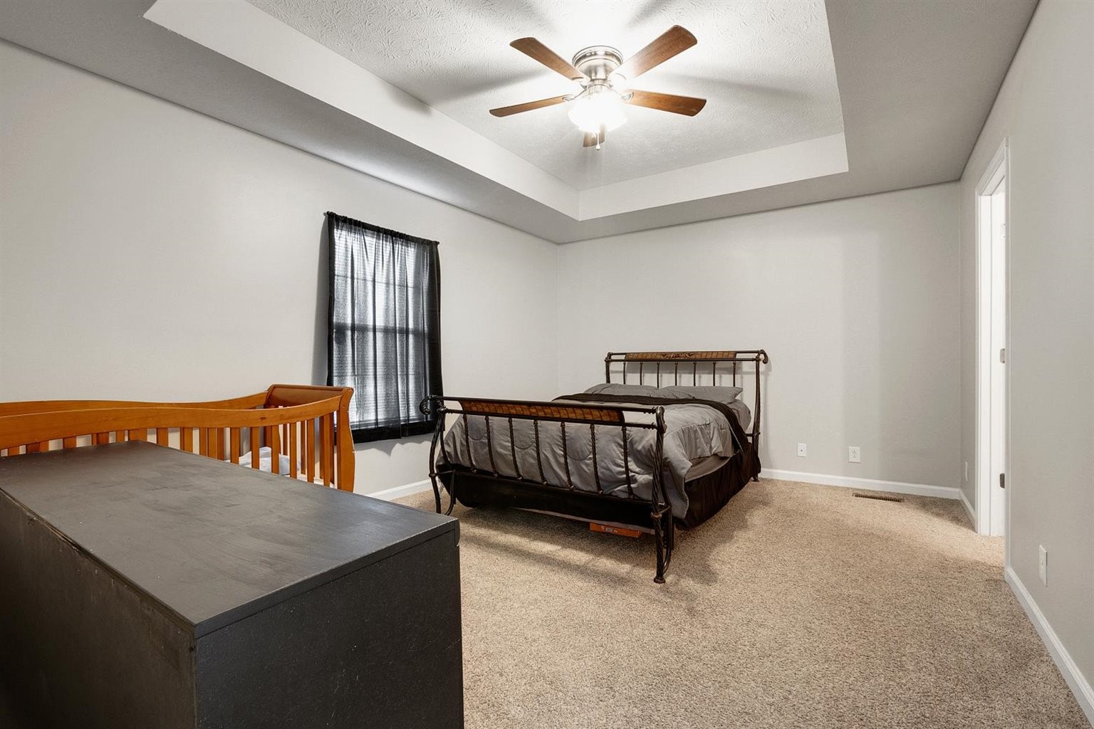 372 Freeland Road Portland, TN 37148 - Photo 10 of 41 a bedroom with a bed and a chandelier