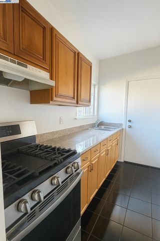 a kitchen with stainless steel appliances granite countertop a refrigerator and cabinets