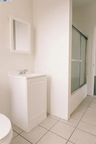 a view of a livingroom with wooden floor and a window