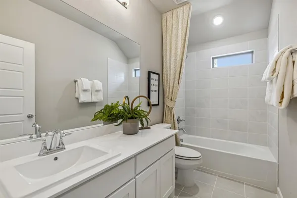 a bathroom with a granite countertop sink a toilet and shower