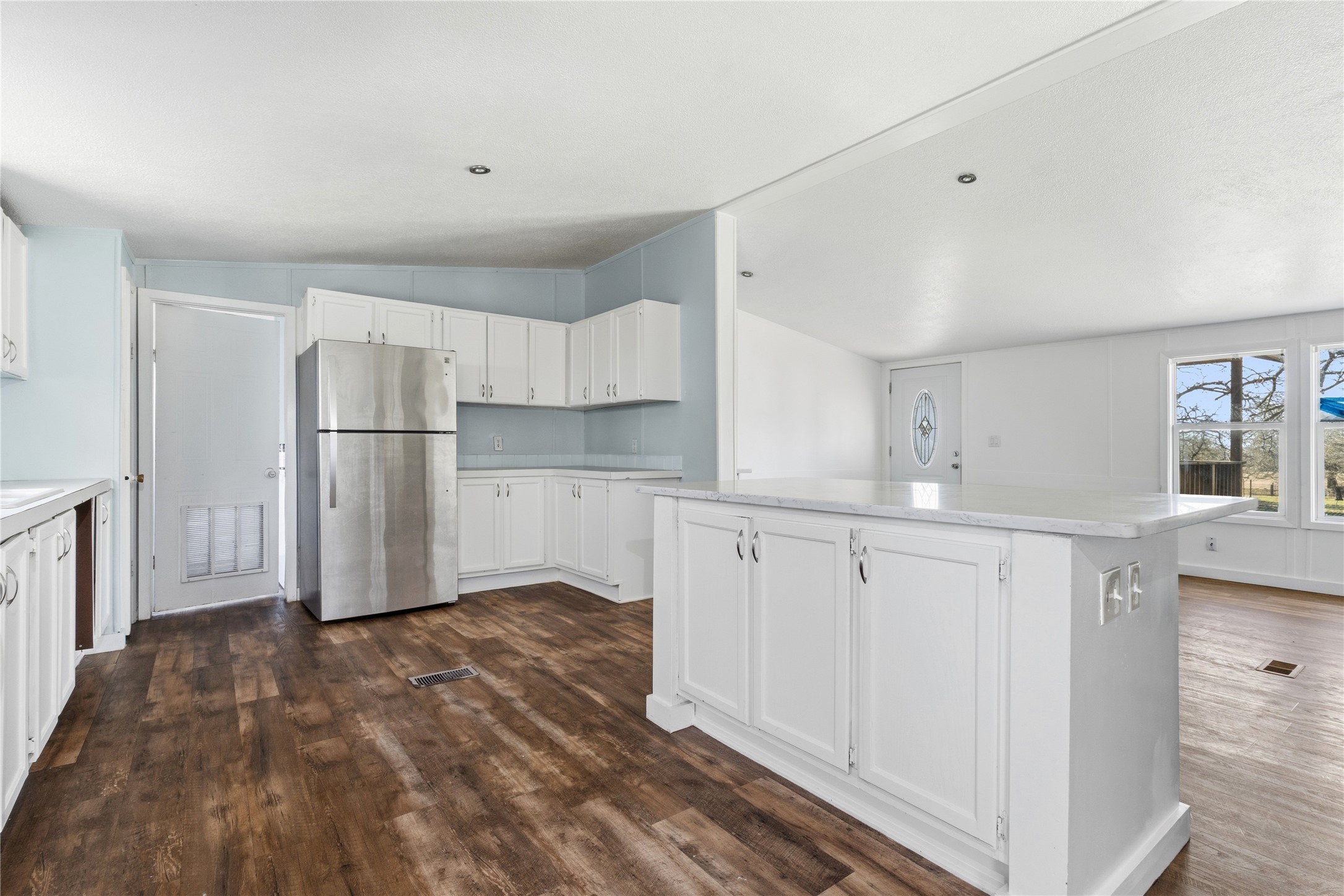 1029 Old McDade Road, Unit C Elgin, TX 78621 - Photo 15 of 33 a kitchen with white cabinets and refrigerator