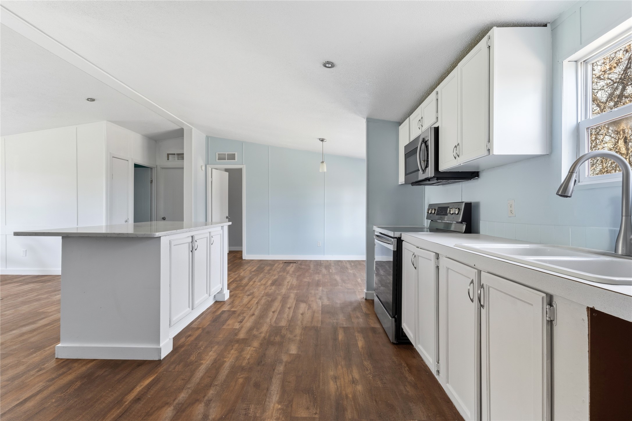 1029 Old McDade Road, Unit C Elgin, TX 78621 - Photo 16 of 33 a kitchen with cabinets and wooden floor