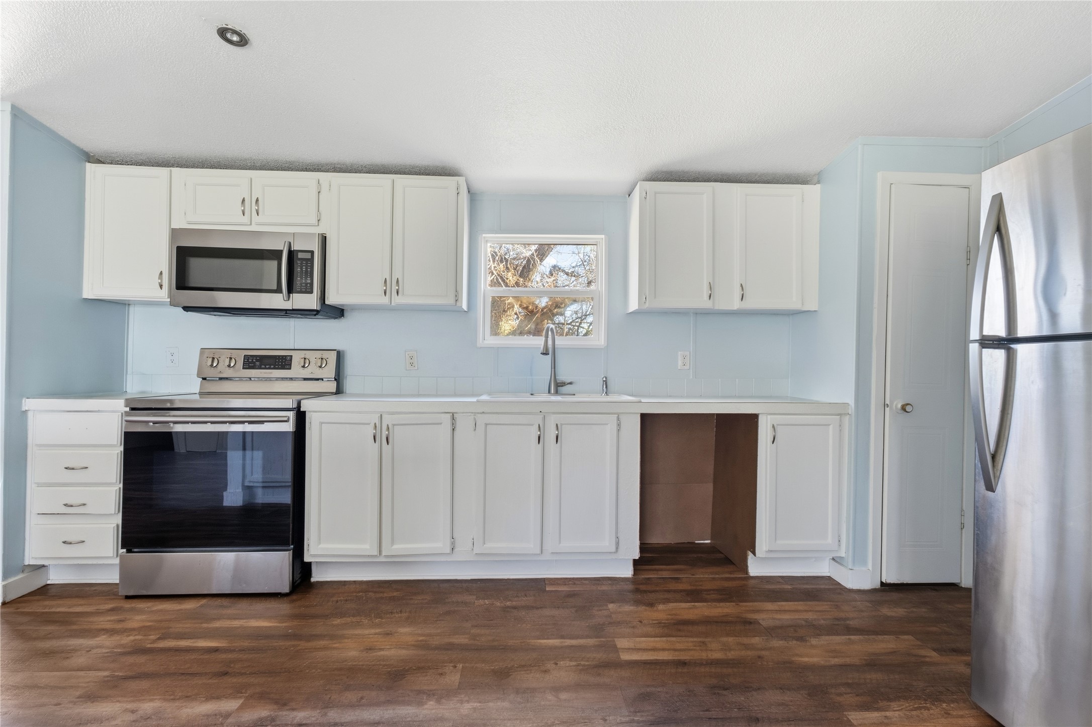 1029 Old McDade Road, Unit C Elgin, TX 78621 - Photo 17 of 33 a kitchen with stainless steel appliances granite countertop a stove and a refrigerator