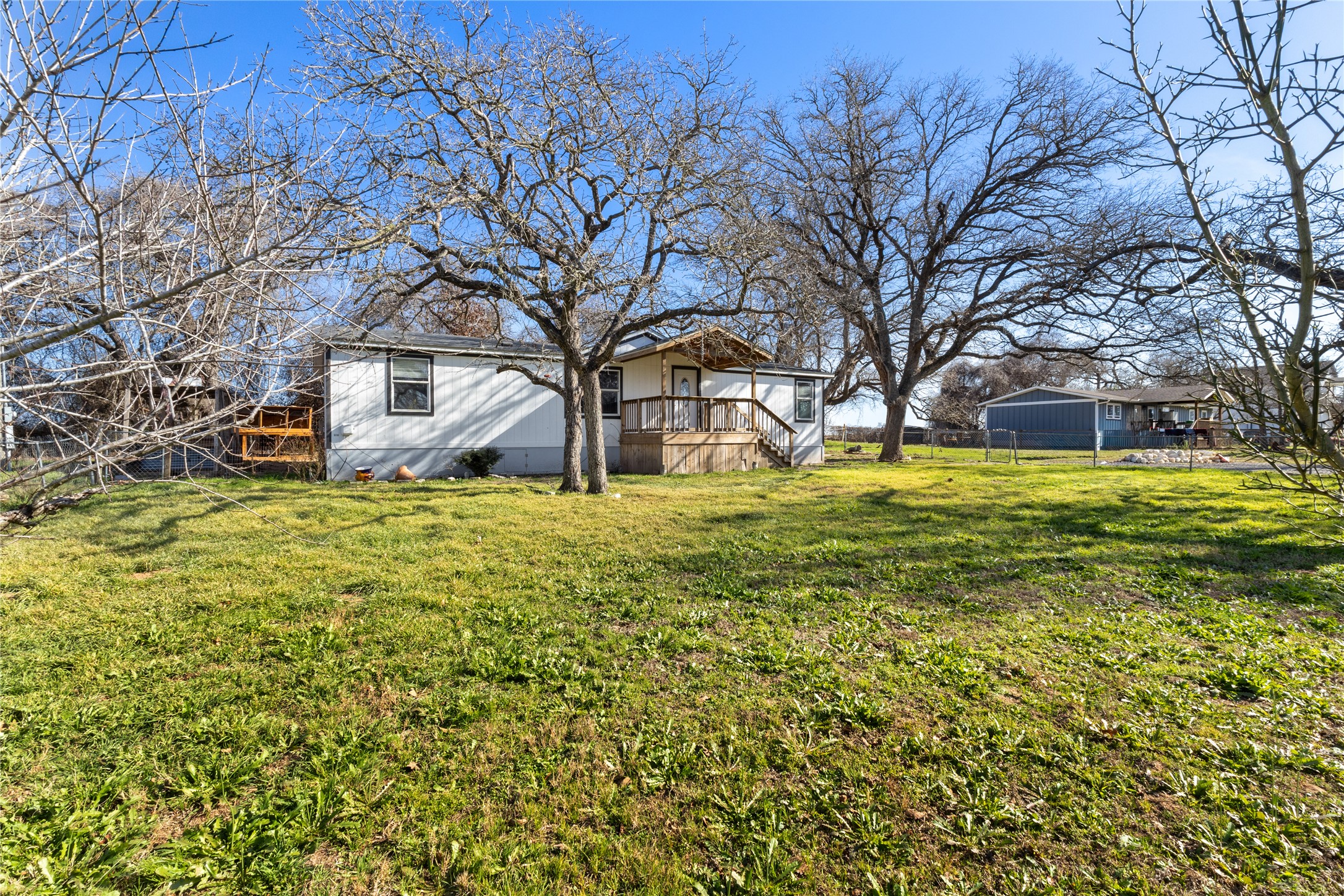 1029 Old McDade Road, Unit C Elgin, TX 78621 - Photo 2 of 33 a view of a yard with large trees