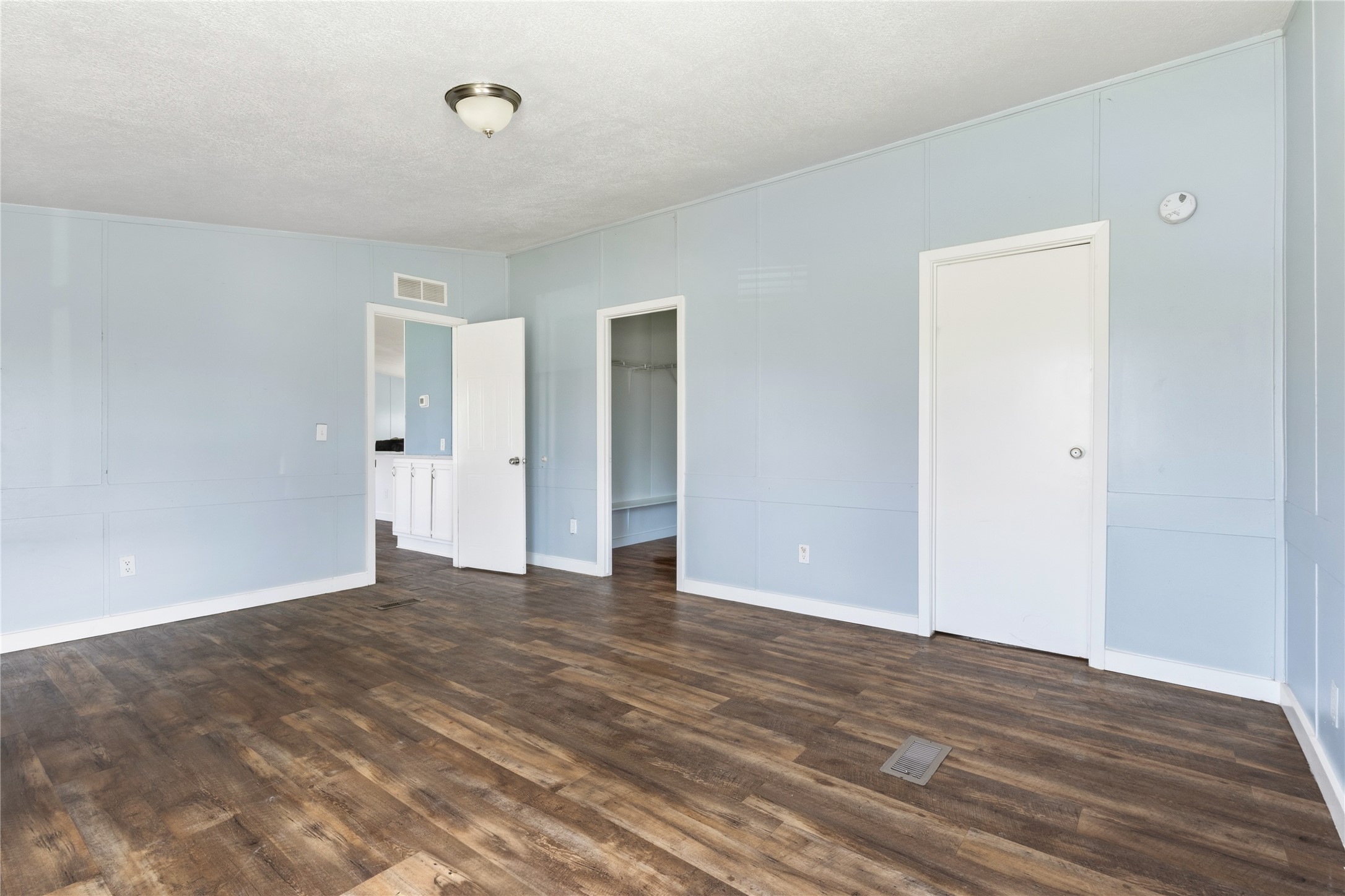 1029 Old McDade Road, Unit C Elgin, TX 78621 - Photo 21 of 33 a view of an empty room with wooden floor and closet