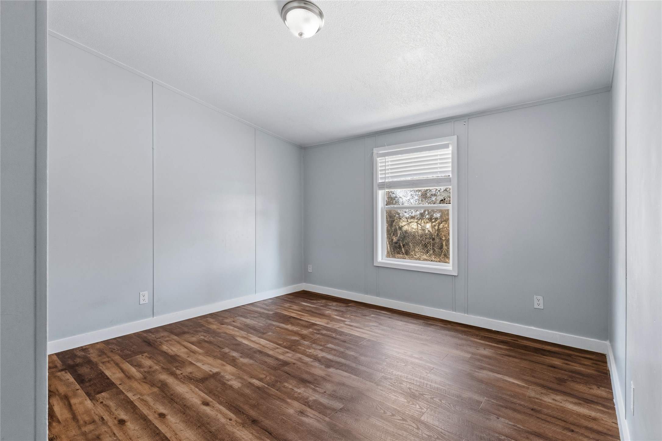 1029 Old McDade Road, Unit C Elgin, TX 78621 - Photo 25 of 33 an empty room with wooden floor and windows