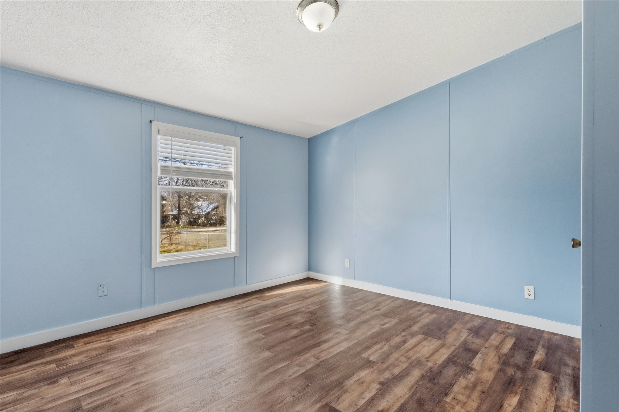 1029 Old McDade Road, Unit C Elgin, TX 78621 - Photo 28 of 33 a view of an empty room with wooden floor and a window