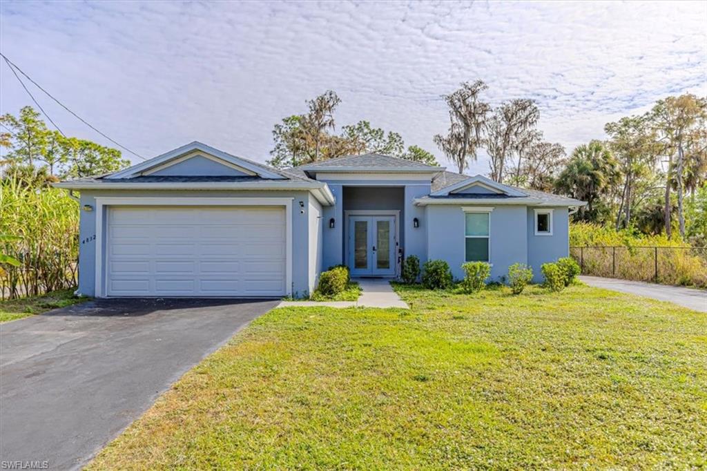 a front view of a house with a yard and garage