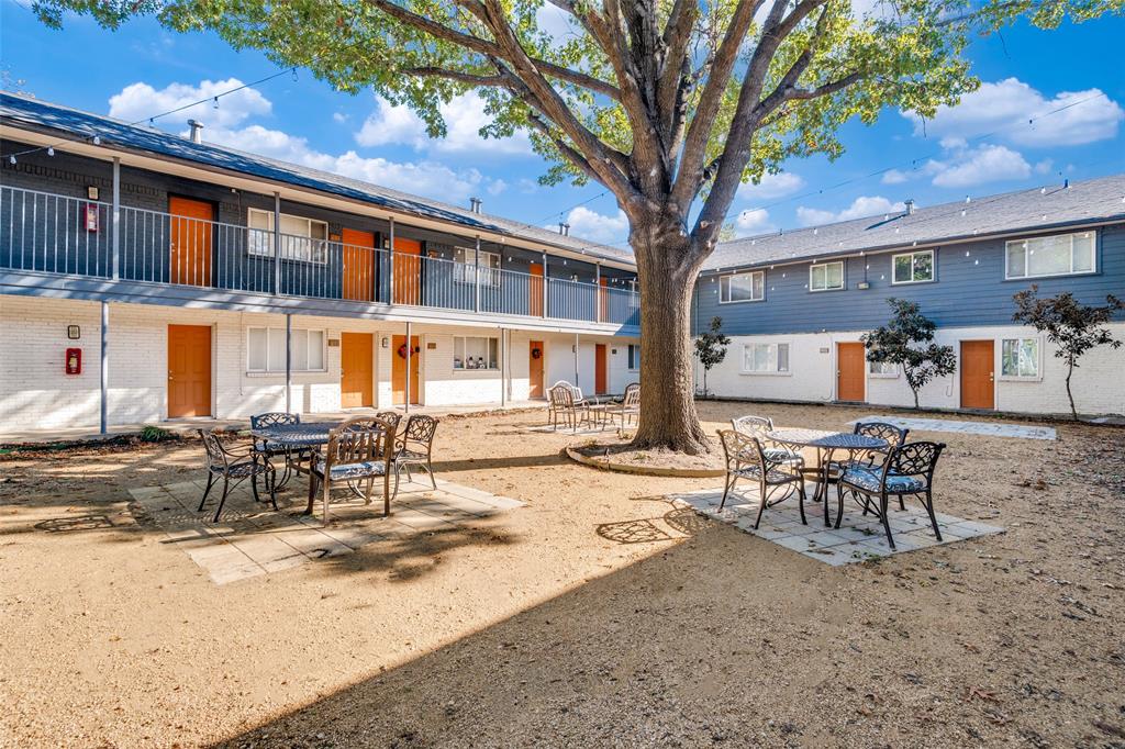 4618 Reiger Avenue, Unit 101 Dallas, TX 75246 - Photo 16 of 17 a wooden bench sitting in front of a building